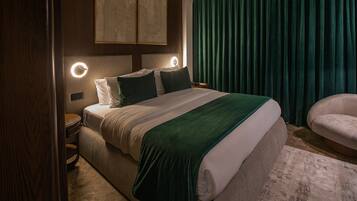 A neatly arranged bedroom with a bed, bedside tables, and a chair.