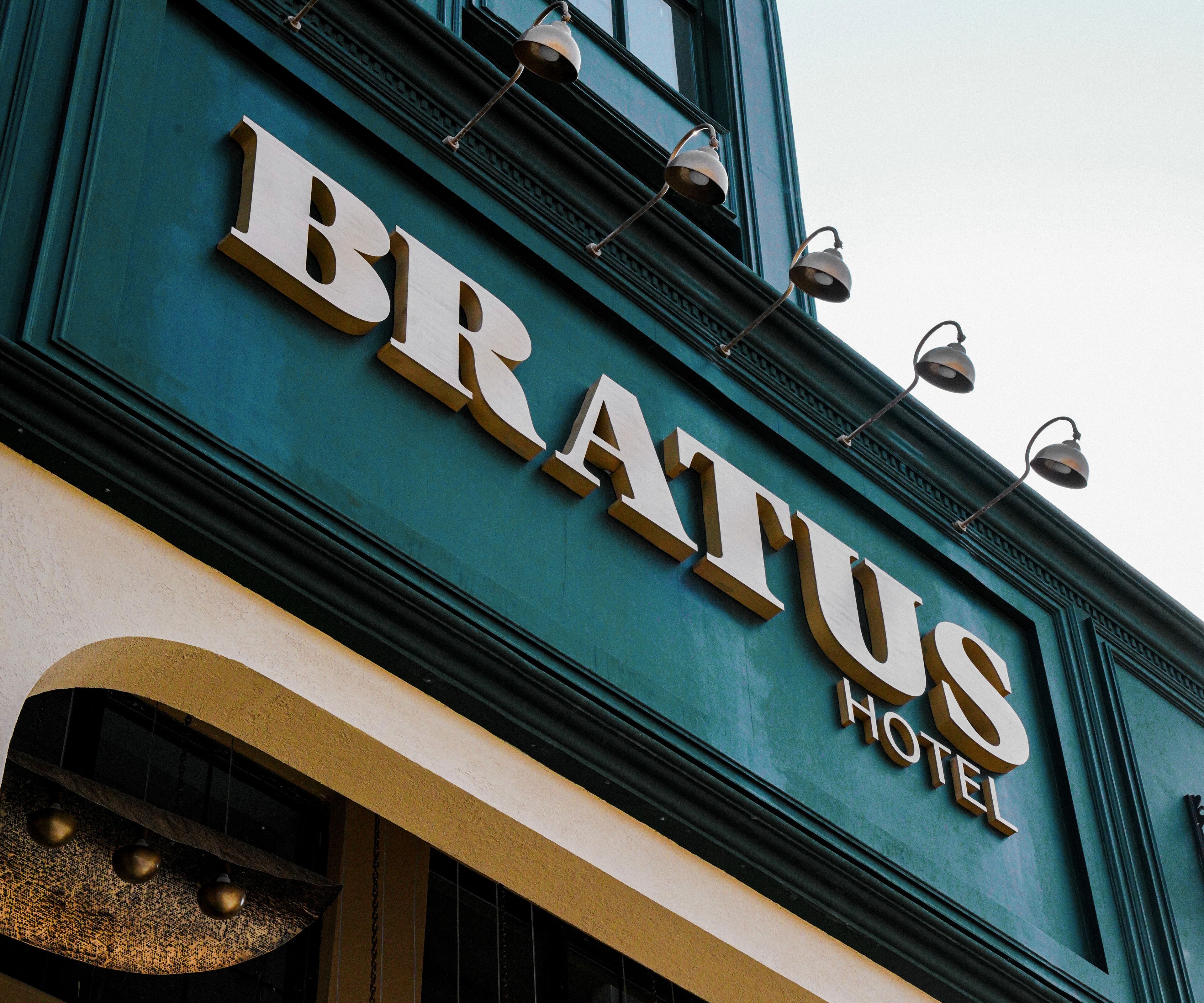The exterior of the Bratus Hotel with its name prominently displayed in large letters.