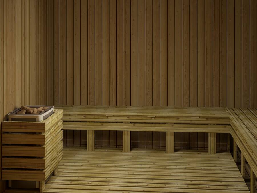 Una sauna de madera con bancos y una zona de estar.