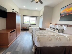 Relax in a stylish room with a large bed, flat-screen TV, and a wardrobe with ample storage.