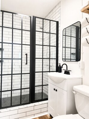 Shower, hair dryer, towels, toilet paper