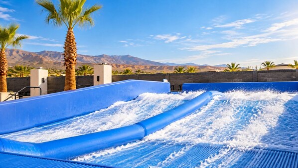 A water slide with a mountainous backdrop.