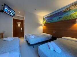 Economy Quadruple Room | Down comforters, memory foam beds, laptop workspace, blackout drapes