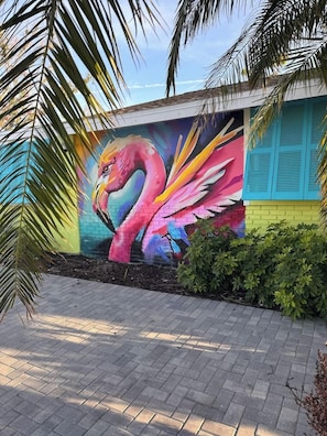 A colorful mural of a flamingo on a building wall. - The Flamingo Waterfront Bungalow (Madeira Beach)