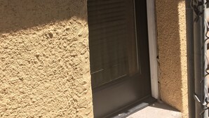 A door with a textured wall and a metal gate. - Downtown Secluded & Peaceful Armory Park 10 min walk to Club Congress (Tucson)