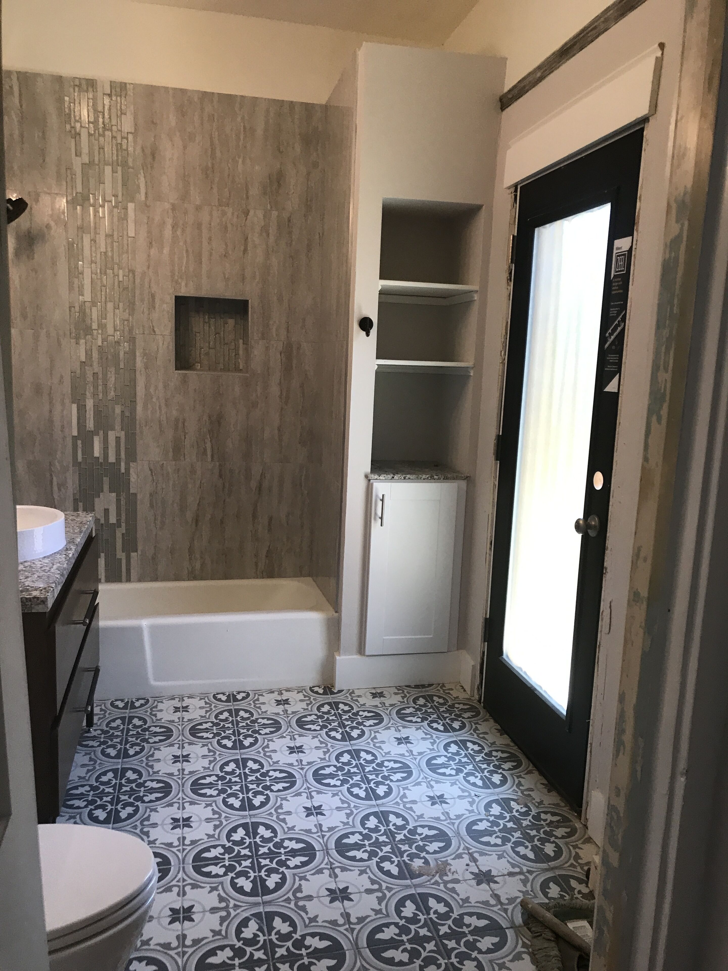 A bathroom with a bathtub, a toilet, and a shower area.