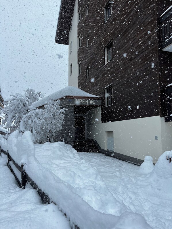 A building with a sign reading "IMPERIAL" and snow-covered surroundings.