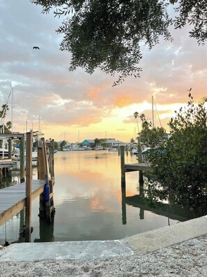 A marina with wooden docks and calm water reflecting the sky.