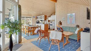 A modern interior with a dining area, kitchen, and living space.
