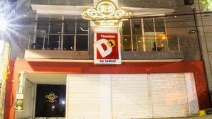 A hotel with a prominent sign, multiple balconies, and a closed front door. - Hotel Dorado san luis (San Luis)
