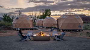 Geodesic dome structures with outdoor seating and a central fire pit. - Skyview Hotel (Torrey)