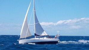 A sailboat on the water with a clear sky.