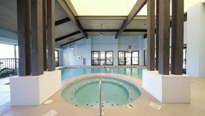An indoor swimming pool with a hot tub, surrounded by large pillars and a high ceiling. - Beautiful Beach Views! Discounts for longer stays in November-March (Orange Beach)