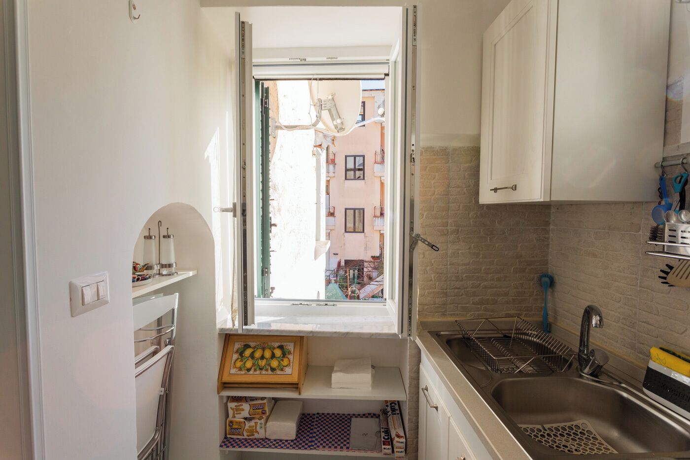 A compact kitchen with a window, a sink, and a small countertop.