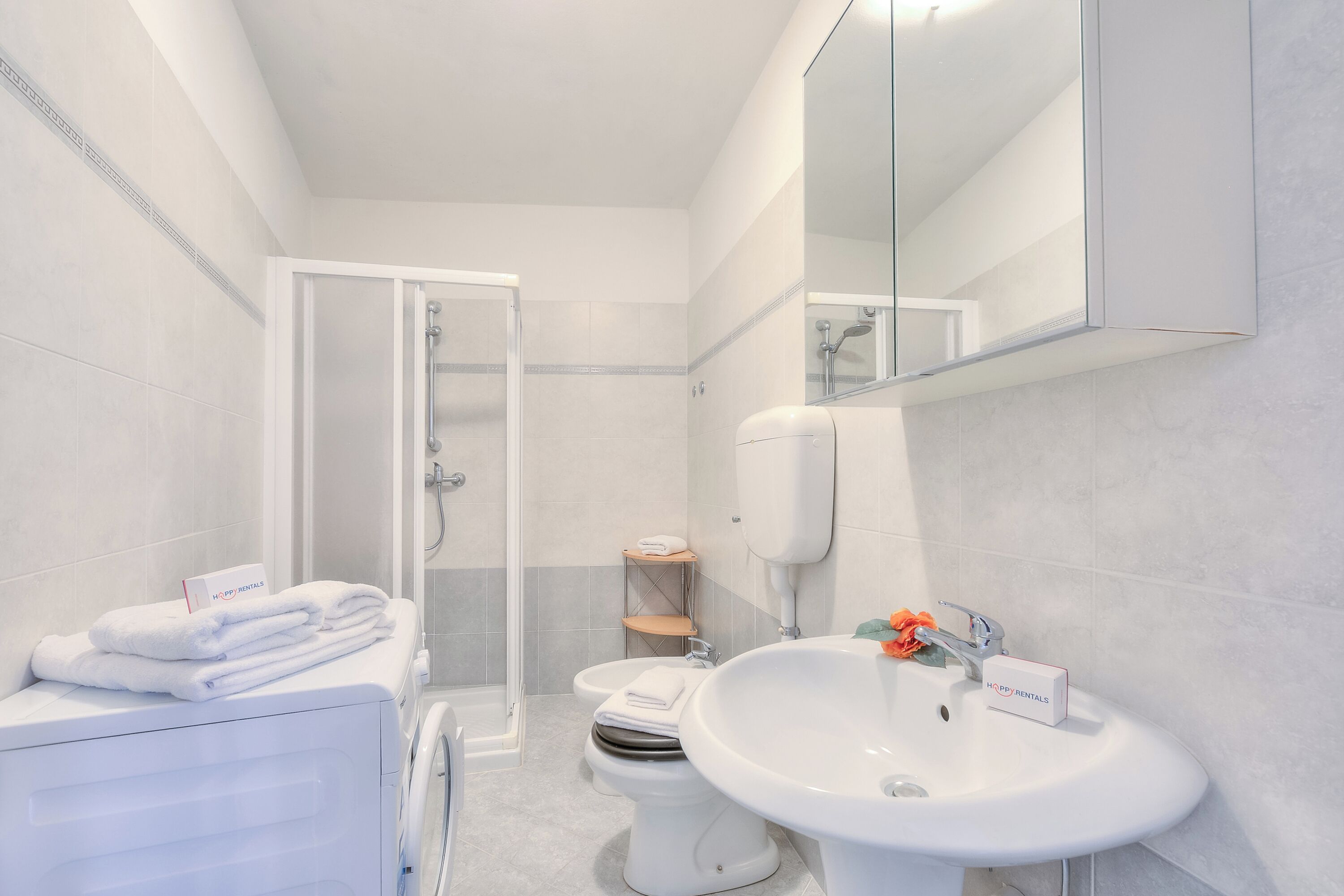 Un baño moderno con ducha, inodoro y lavamanos.