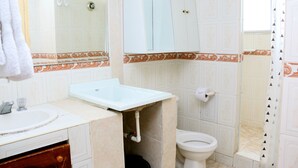 A bathroom with a sink, toilet, and mirror. - Apartment in Cartagena Ocean Front Num1c5 (Cartagena)