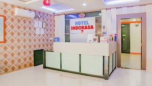 A hotel reception desk with a sign reading "HOTEL INDORASA 2". - OYO 90269 Hotel Indorasa 2 (Batam)