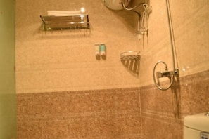 A bathroom with a shower, a towel rack, and a soap dispenser. - Xingyue Courtyard-Style Hotel (Xiaojin)