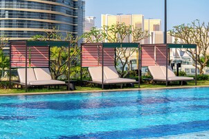 Seasonal outdoor pool, open 9:00 AM to 7:00 PM, pool umbrellas