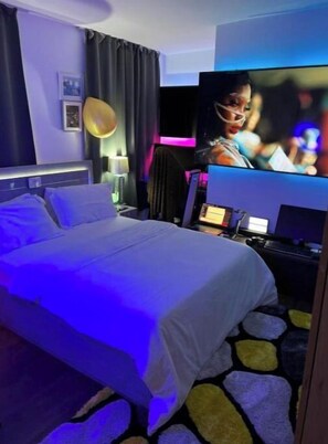 Relax in a stylish room with a comfortable bed, flat-screen TV, and desk for work or leisure.
