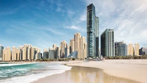A coastal cityscape with high-rise buildings, a beach, and ocean waves. - Al Bateen - Ultra Luxury JBR - Private Beach and Pool (Dubai)
