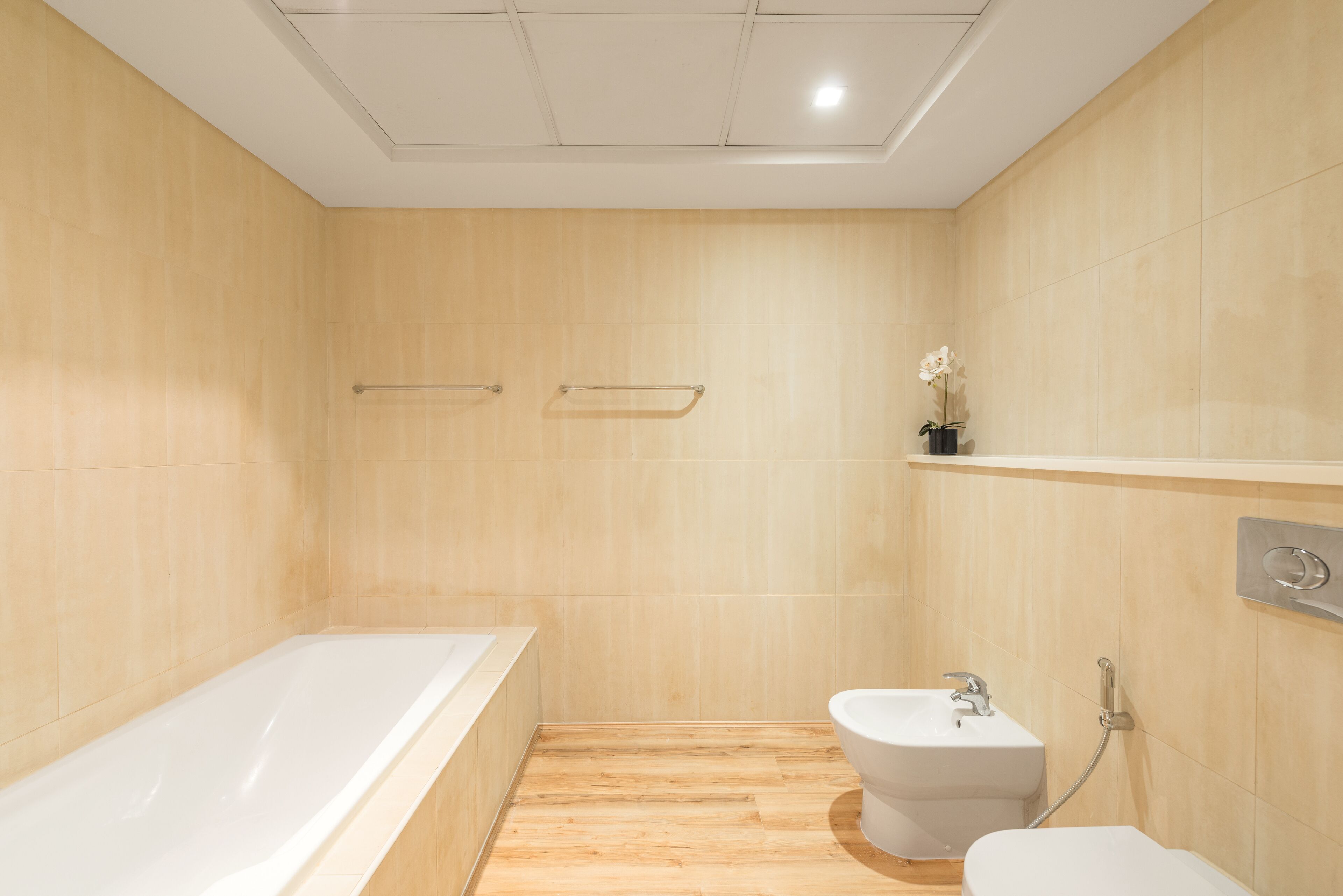 A modern bathroom with a bathtub, a sink, and a toilet.