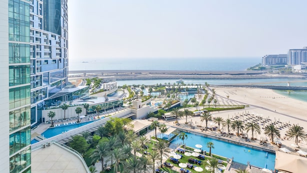 A high-rise hotel with a pool area, beach view, and multiple amenities. - Al Bateen - Ultra Luxury JBR - Private Beach and Pool (Dubai)
