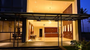 A modern hotel entrance with a reception desk, glass doors, and a covered waiting area. - Clarks Inn Express, KRS Road, Mysore (Mysore)