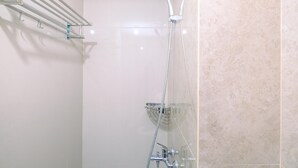 A shower with a handheld showerhead, a glass shower tray, and a metal towel rack. - Great Choice And Comfortable Studio Transpark Cibubur Apartment (Depok)