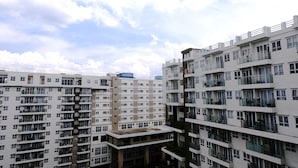 A multi-story residential building with balconies, large windows, and a flat roof. - Best Location 2Br At Gateway Pasteur Apartment (Cimahi)