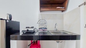 A compact kitchen with a gas stove, a sink, and a small countertop.