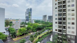 A high-rise building with multiple floors, surrounded by greenery and other buildings. - Elegant And Tidy 1Br Apartment Silkwood Residences (Tangerang)