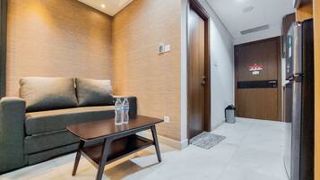 Apartamento luxo, 1 quarto | Área de estar