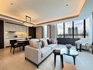 Mulberry Grand Suite (Two-Bedroom) | Living area | 65-inch Smart TV with digital channels, TV - SILQ Hotel And Residence (Bangkok)