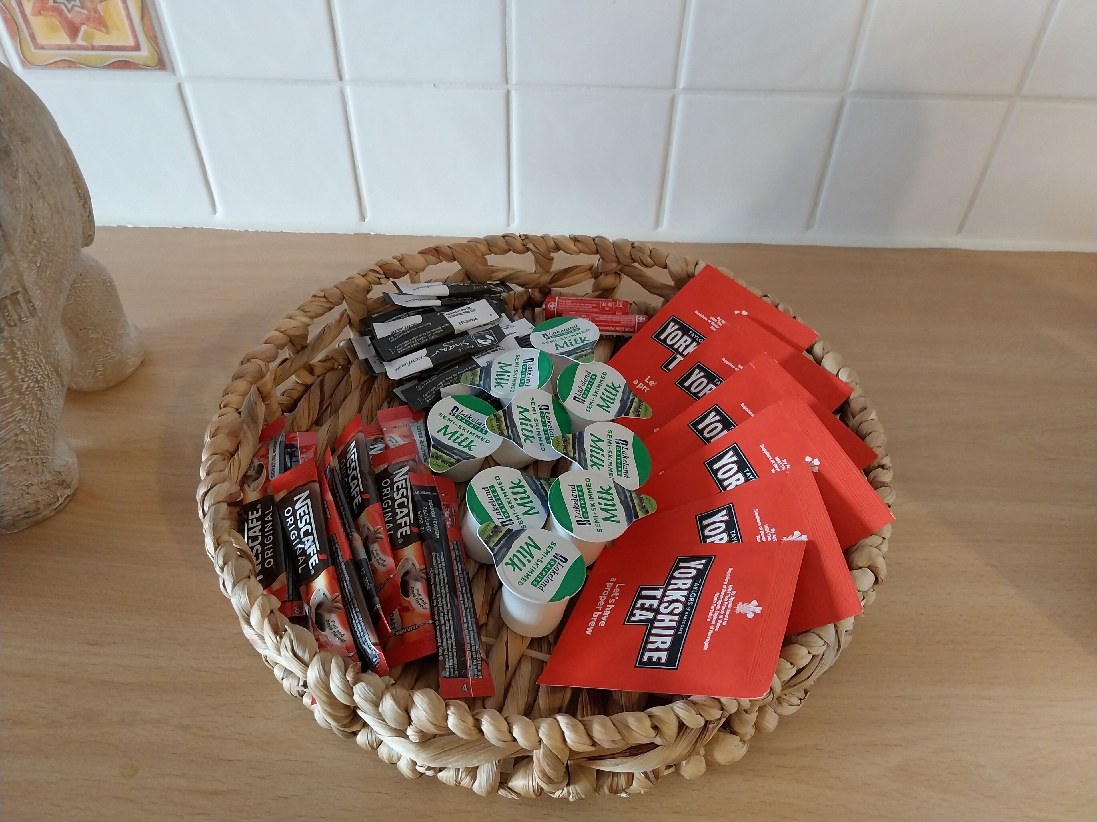 A basket containing various tea and coffee products.