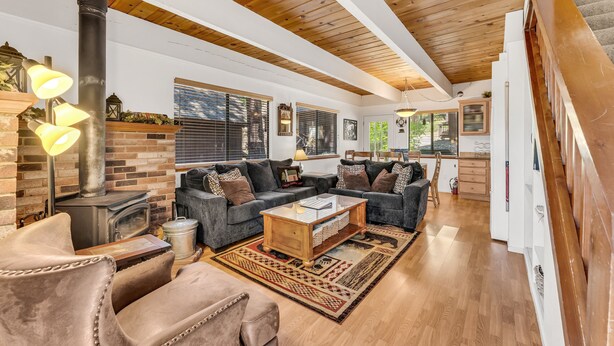 A cozy living room with a fireplace, a sofa set, and a coffee table. - Cozy Mountain Hideaway 3 Bedroom Home by RedAwning (Incline Village)