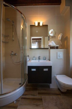 A bathroom with a glass-enclosed shower, a sink with a mirror above, and a toilet. - Beautiful 4-bed Villa for up to 10 Guests (Konavle)