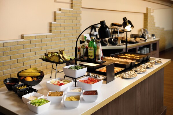 A buffet with various food items and condiments. - Aranyhomok Hotel Business & Relax (Kecskemet)