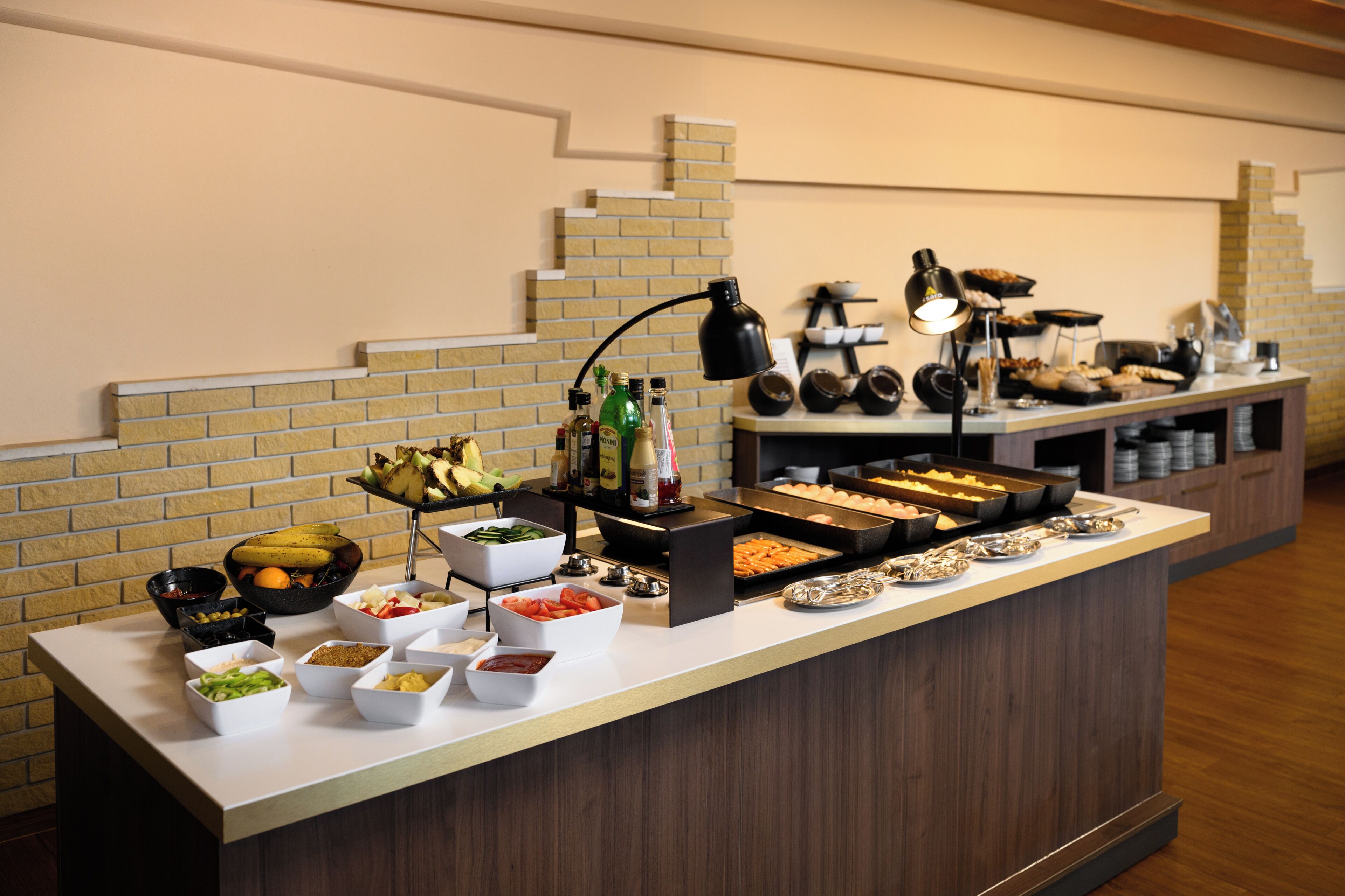 A buffet with various food items and condiments.