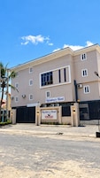 A two-story building with a sign reading 'Residency Hotel' and 'Zuriyard.'