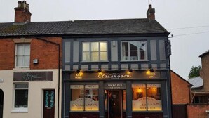 A two-story building with a sign for 'Classroom' on the ground floor, indicating it might be a pub or bar. - Cosy Twin or Double Studio Near Shearsby, England (Lutterworth)