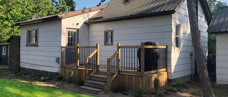 View from outside. Living room on the left, bedrooms on the right. BBQ included