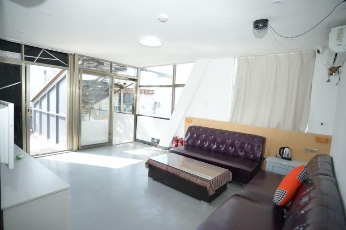 A modern living room with a sofa, a coffee table, and a view of a staircase.