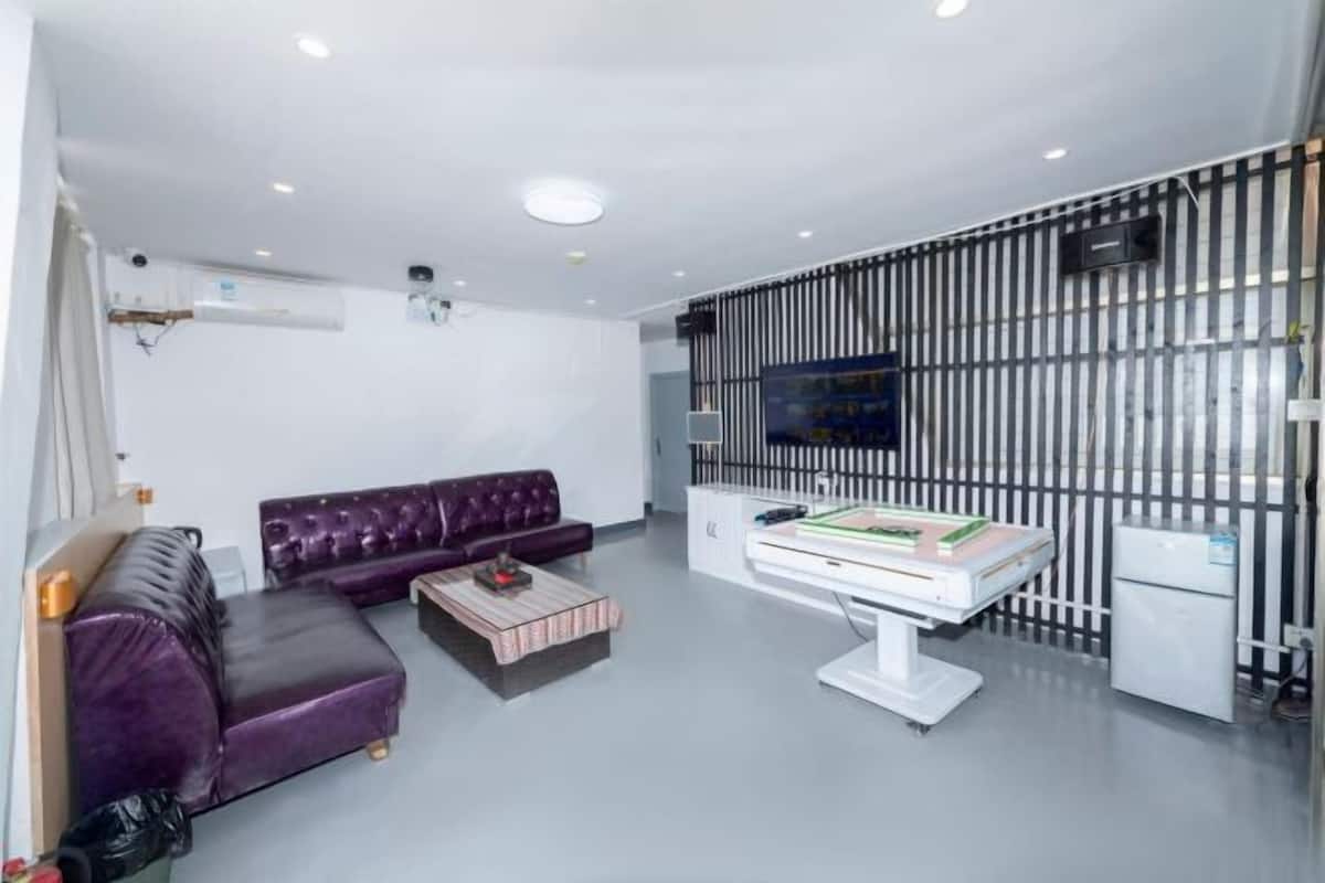 Una sala moderna con un sofá modular, una mesa de centro y un televisor.