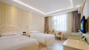 A hotel room with two beds, a small desk, a chair, and a television. - Zihong Hotel (Yuxi)
