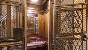A narrow, enclosed stairwell with a bench and a suitcase. -  magenta collection navona (Rome)