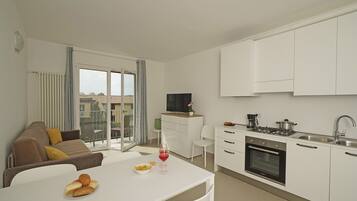 Superior Apartment | Living area | 15-inch flat-screen TV with satellite channels, TV