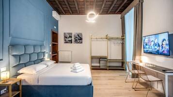 Una habitación de hotel moderna con una cama grande, un escritorio y una televisión.