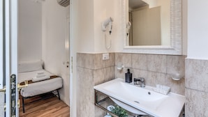 A modern bathroom with a white sink, mirror, and hairdryer. - Magenta Collection Cancello (Rome)