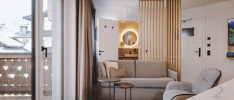A modern interior with a sofa, a small table, and a chair.